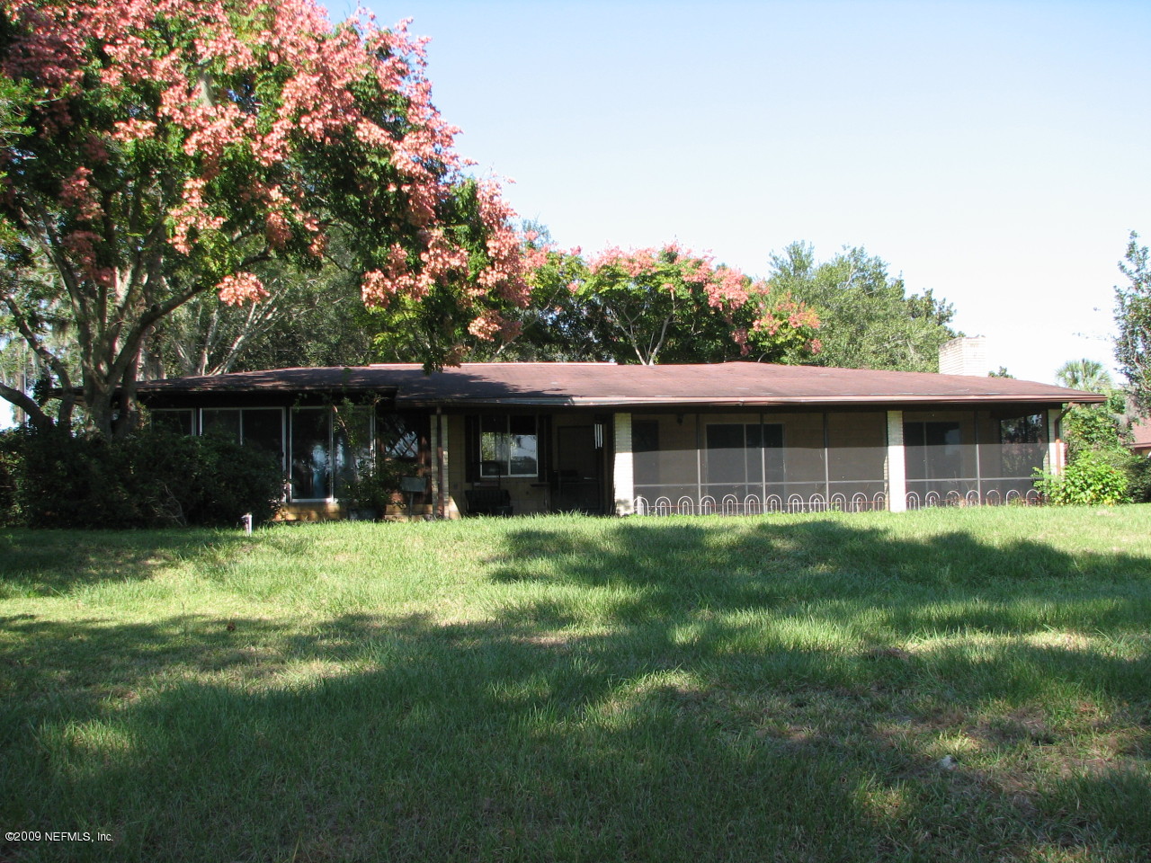 6849 Southeast 35th Street Keystone Heights, FL 32656 - Photo 1 of 4 a front view of a house with a yard