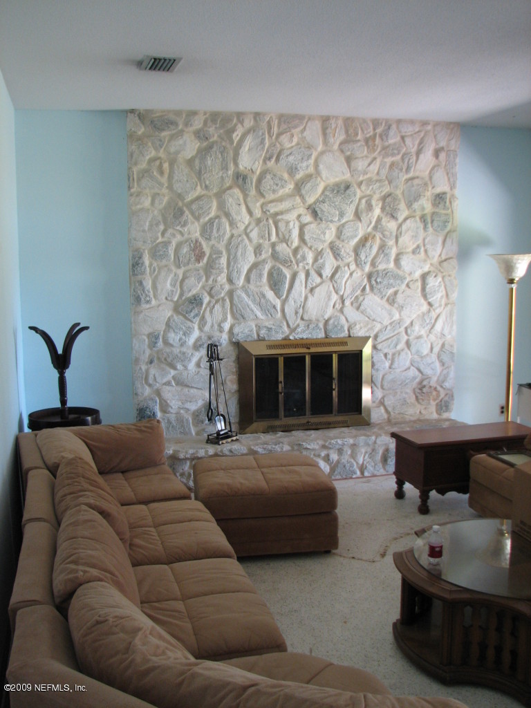 6849 Southeast 35th Street Keystone Heights, FL 32656 - Photo 4 of 4 a bedroom with furniture and a fireplace