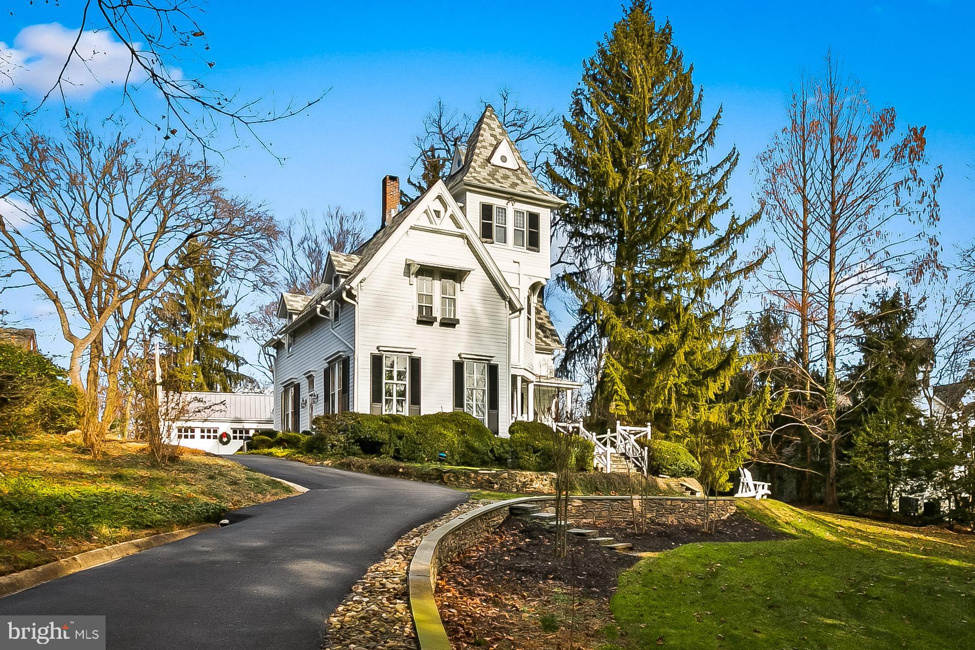 a view of a white house with a yard