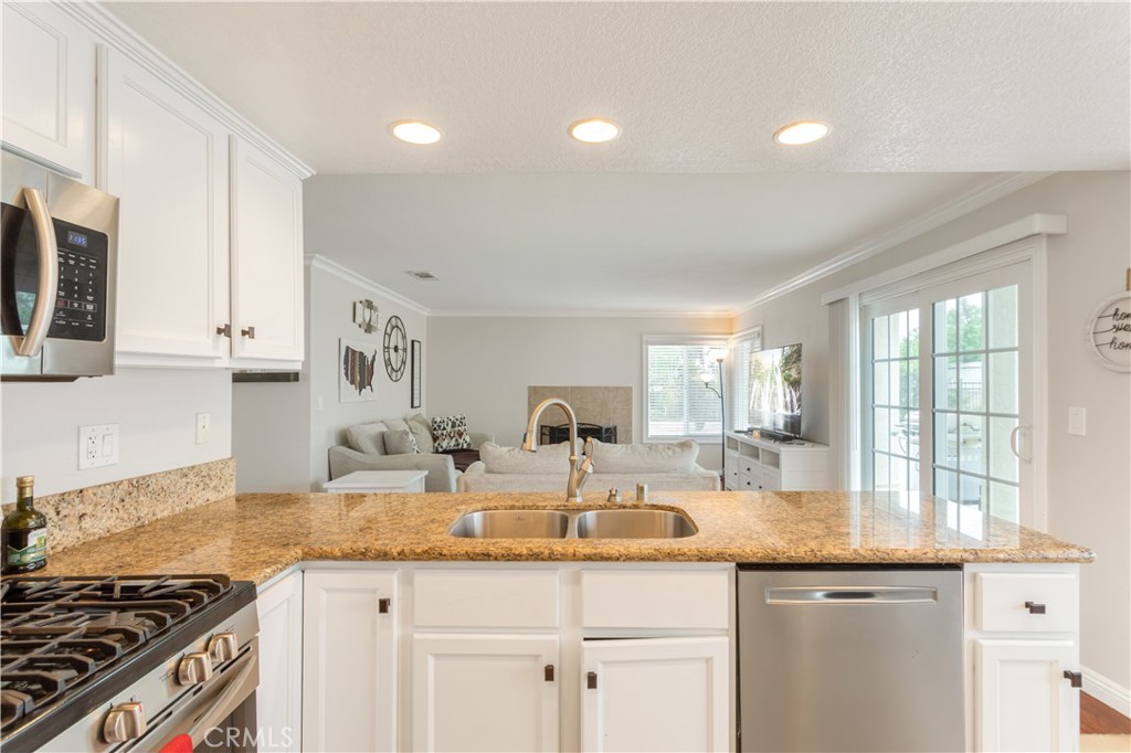 934 Mission Grove Riverside, CA 92506 - Photo 11 of 28 a kitchen with granite countertop a sink and a stove