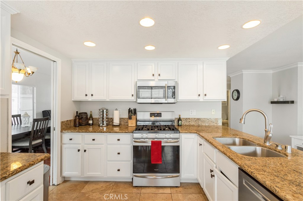 934 Mission Grove Riverside, CA 92506 - Photo 13 of 28 a kitchen with stainless steel appliances granite countertop a sink stove and cabinets