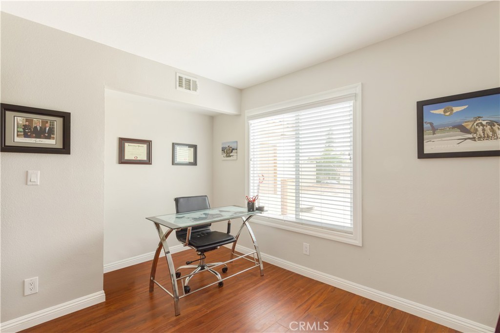 934 Mission Grove Riverside, CA 92506 - Photo 15 of 28 a workspace with wooden floor and a window
