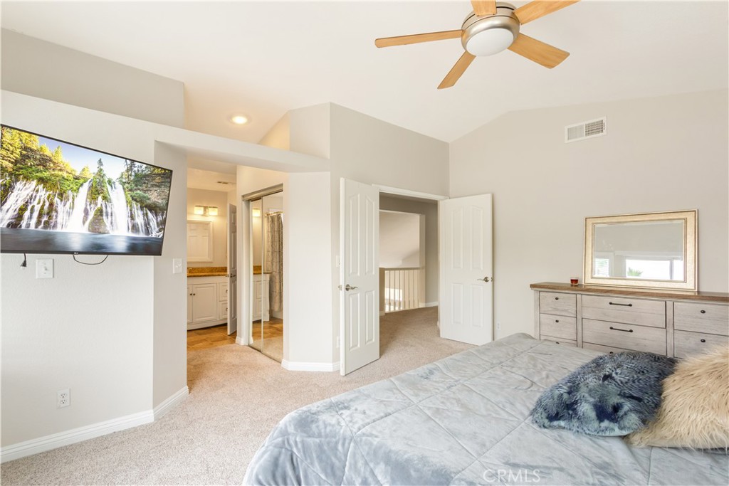 934 Mission Grove Riverside, CA 92506 - Photo 18 of 28 a bedroom with a bed and a chandelier