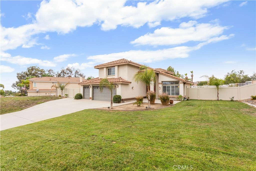934 Mission Grove Riverside, CA 92506 - Photo 2 of 28 a view of a white house with a big yard and large trees