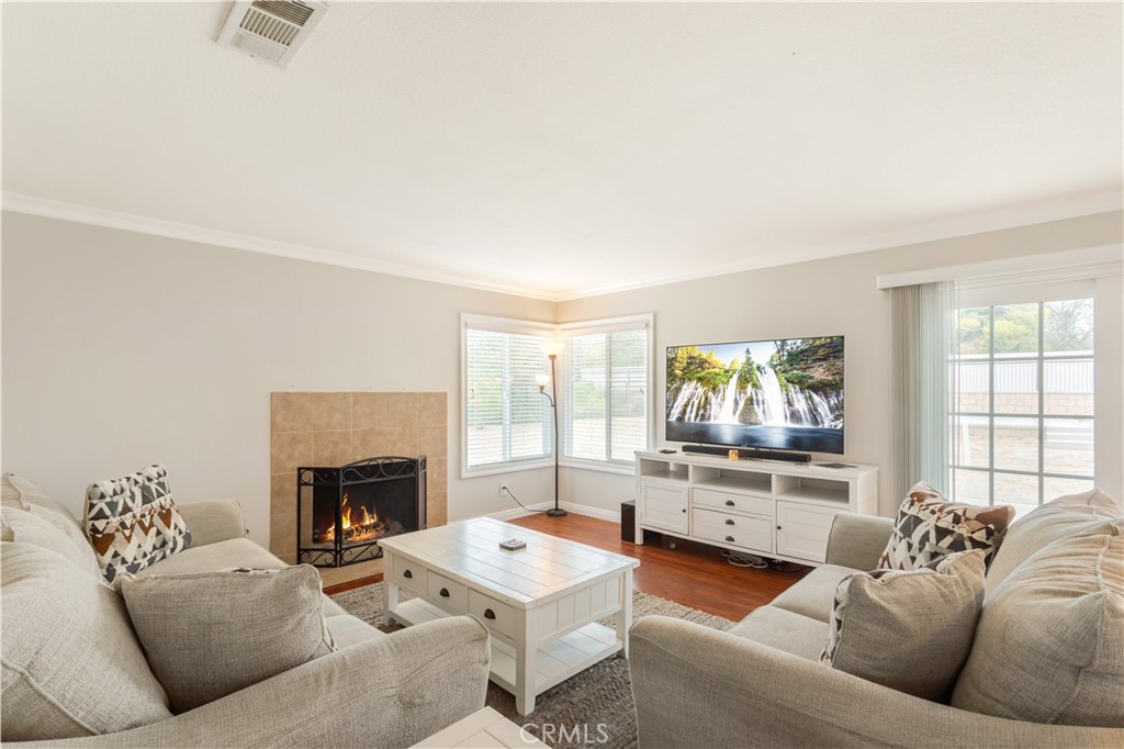 934 Mission Grove Riverside, CA 92506 - Photo 10 of 28 a living room with furniture a flat screen tv and a fireplace