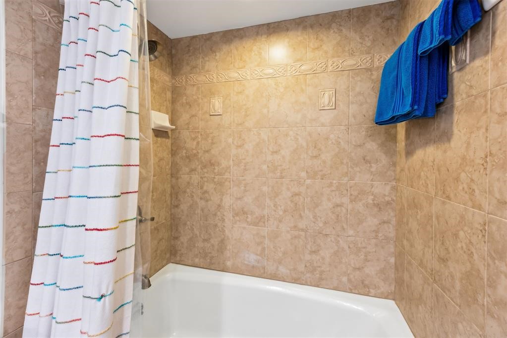 3033 Sea Marsh Road Fernandina Beach, FL 32034 - Photo 23 of 37 a bathroom with a shower curtain and a shower curtain