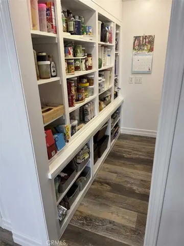 a view of a kitchen with fridge and rack