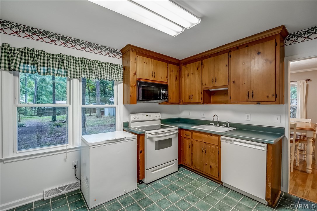 4906 Rollingway Road Chesterfield, VA 23832 - Photo 13 of 34 a kitchen with a stove sink and microwave