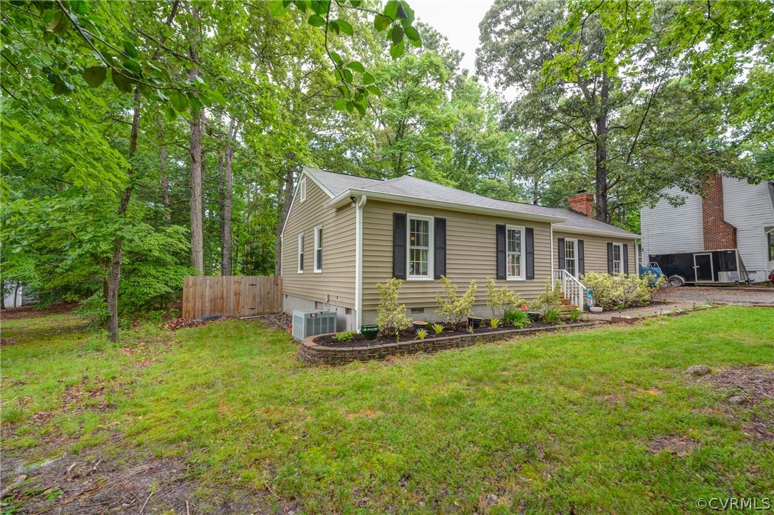4906 Rollingway Road Chesterfield, VA 23832 - Photo 3 of 34 a front view of house with yard and trees in the background