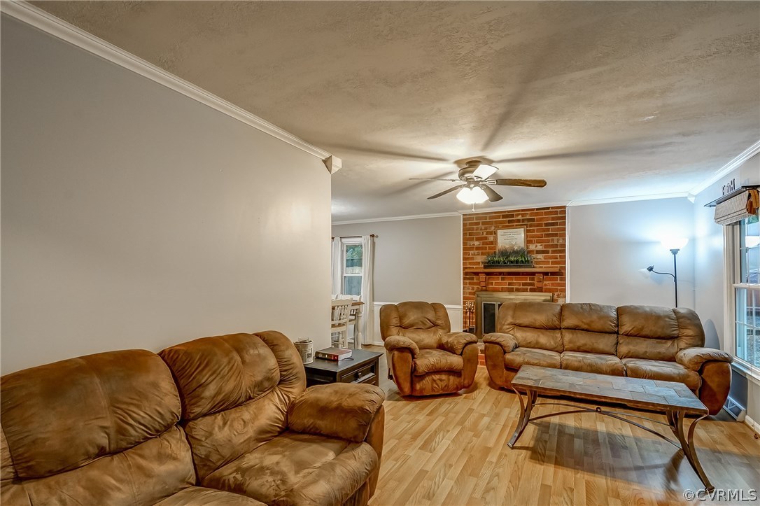 4906 Rollingway Road Chesterfield, VA 23832 - Photo 7 of 34 a living room with furniture a ceiling fan and a rug