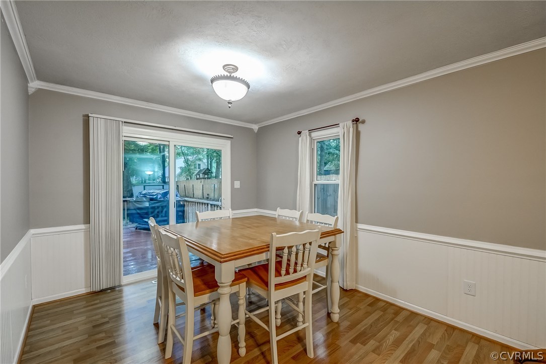 4906 Rollingway Road Chesterfield, VA 23832 - Photo 8 of 34 a view of a dining room with furniture window and wooden floor