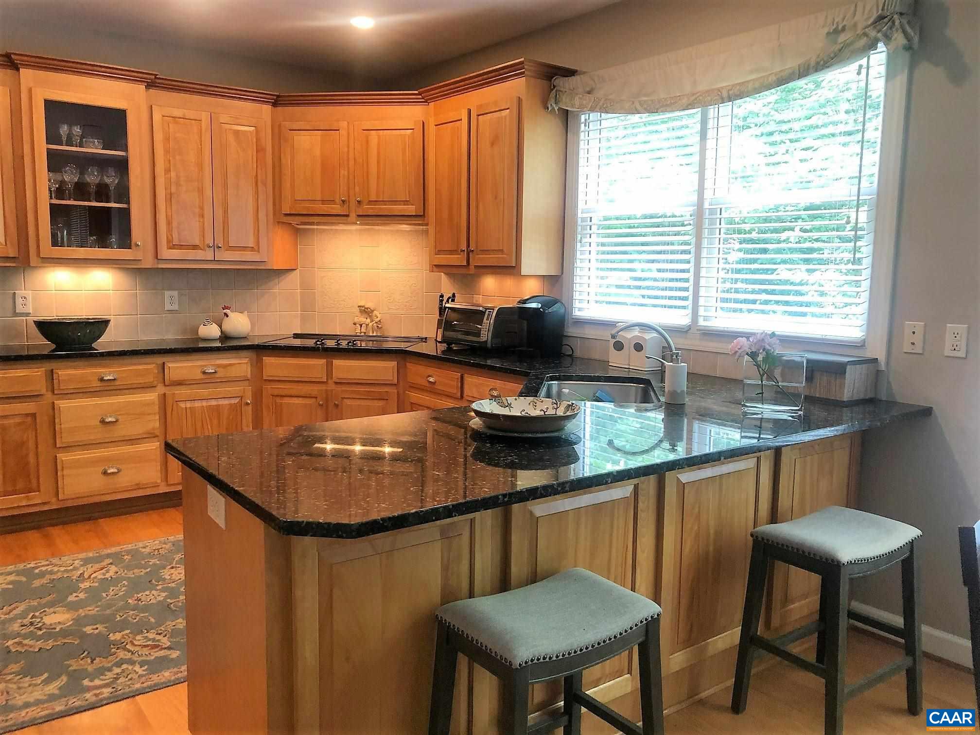 3 Old Farm Road Charlottesville, VA 22903 - Photo 16 of 66 a kitchen with stainless steel appliances granite countertop a sink a stove a table and chairs