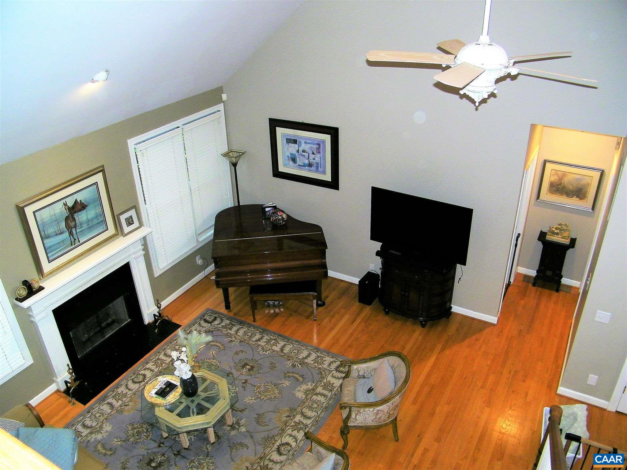 3 Old Farm Road Charlottesville, VA 22903 - Photo 20 of 66 a living room with furniture a fireplace and a flat screen tv