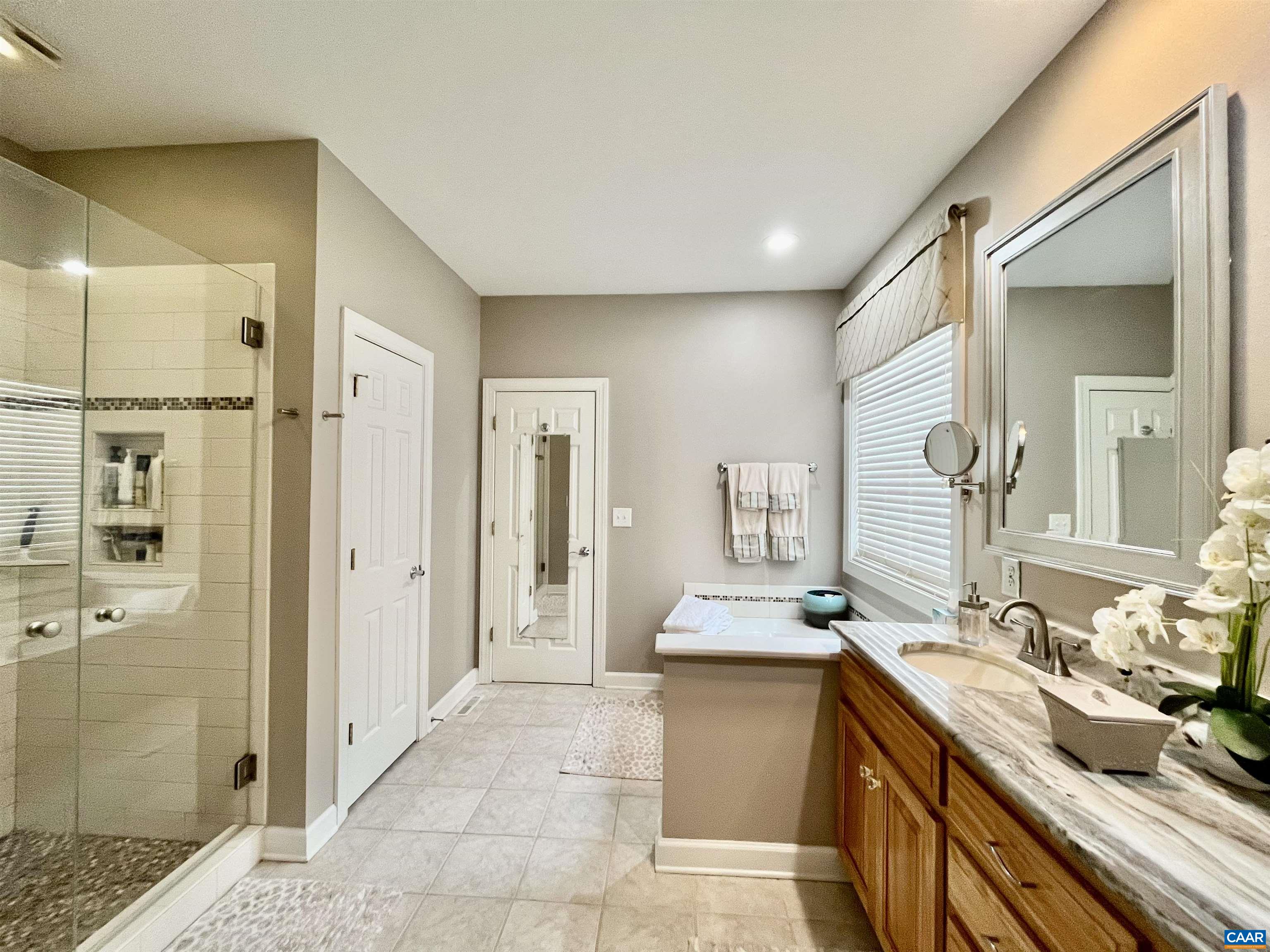 3 Old Farm Road Charlottesville, VA 22903 - Photo 29 of 66 a spacious bathroom with a mirror sink and shower