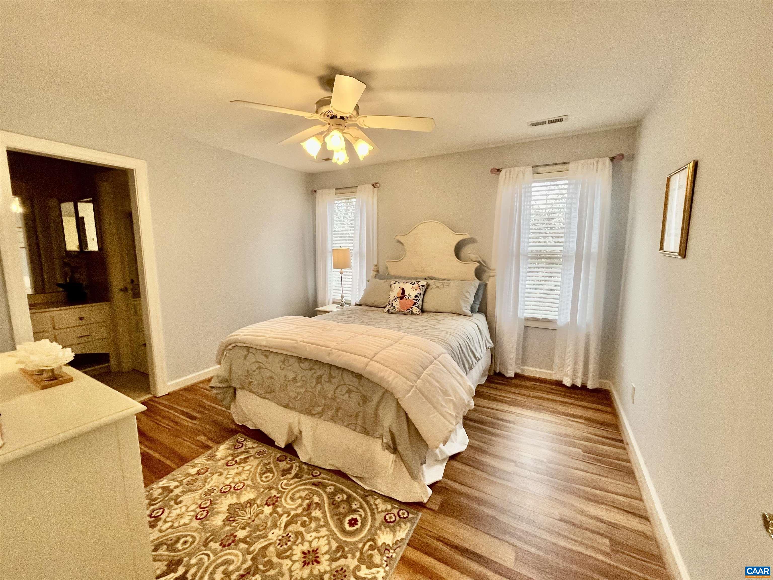 3 Old Farm Road Charlottesville, VA 22903 - Photo 39 of 66 a bedroom with a large bed and a chandelier