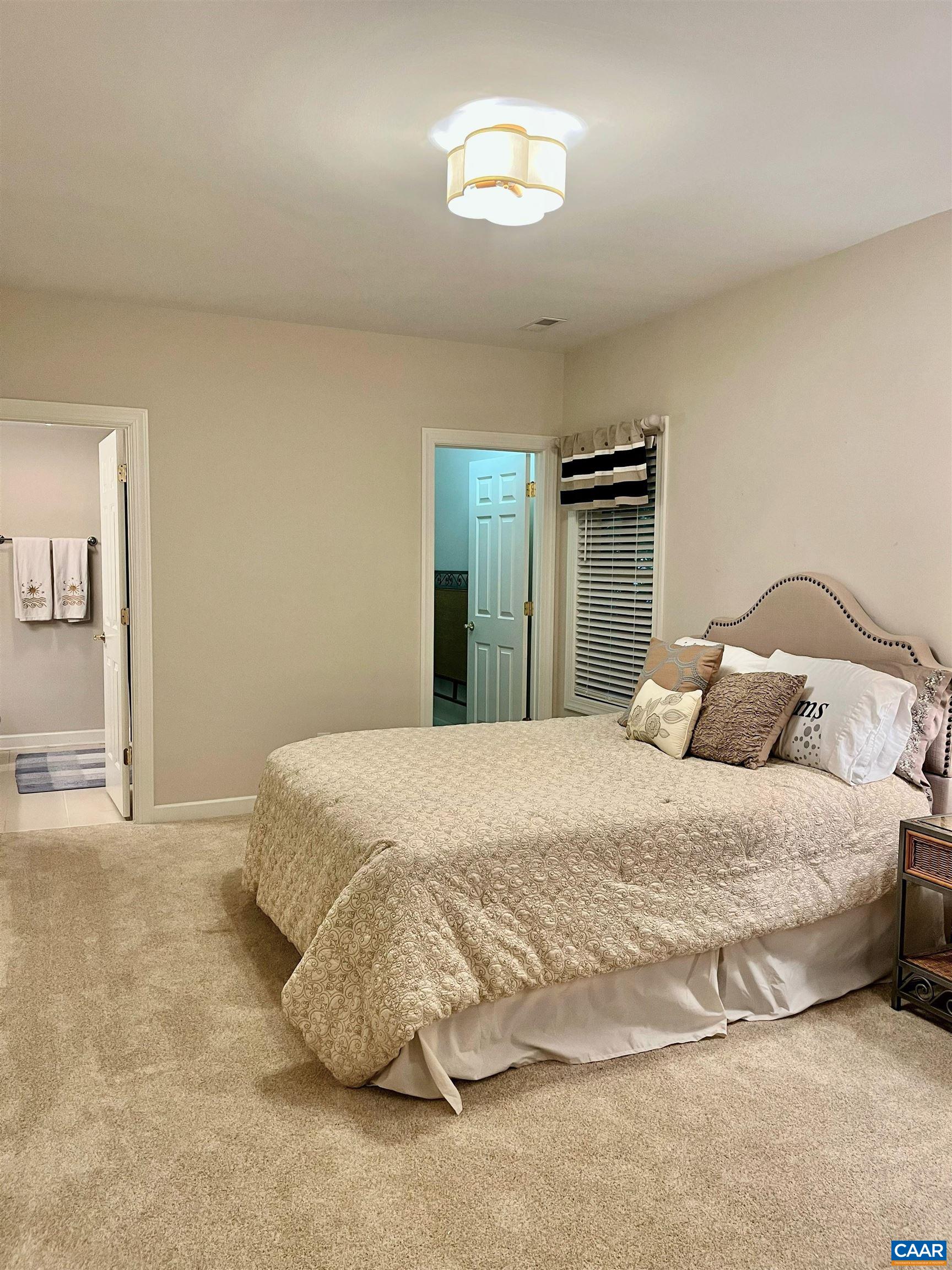 3 Old Farm Road Charlottesville, VA 22903 - Photo 49 of 66 a bedroom with a bed and a lamp