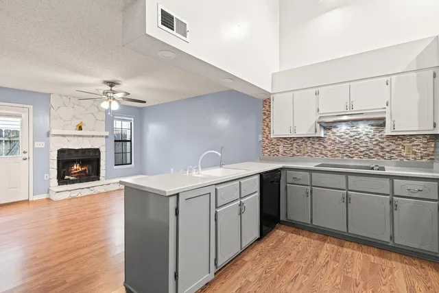 a view of an empty room with a fireplace and a window