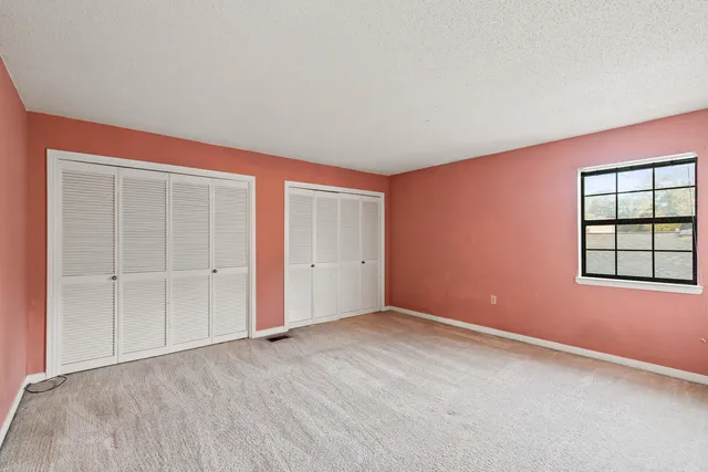 an empty room with fan and a ceiling fan