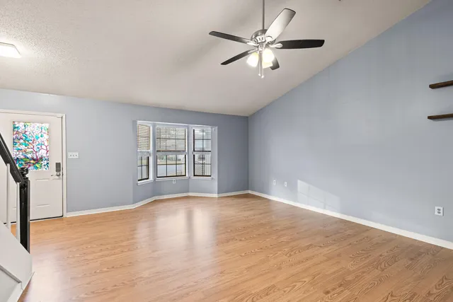 a bathroom with a granite countertop sink mirror and a bathtub