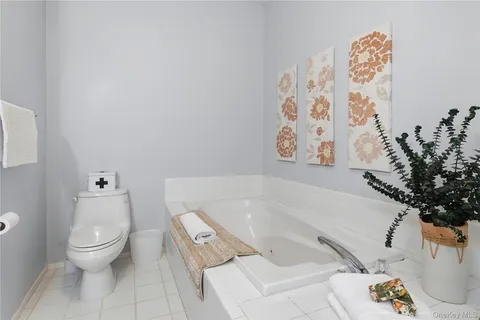 a bathroom with a granite countertop sink a mirror and shower