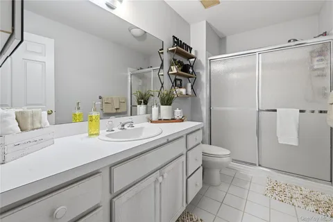 a spacious bedroom with a bed and a chandelier