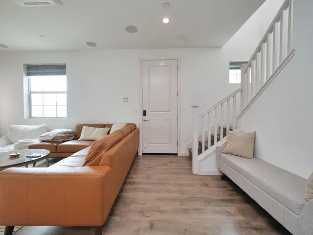 a living room with furniture and stairs