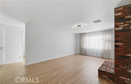 a room with a window and a dresser