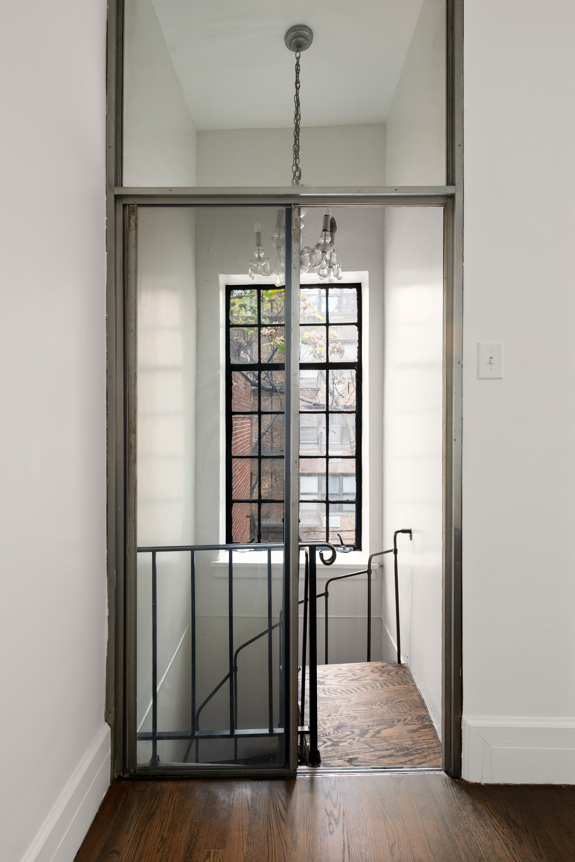 51 East 75th Street Manhattan, NY 10021 - Photo 12 of 22 a view of a hallway with wooden floor and stairs