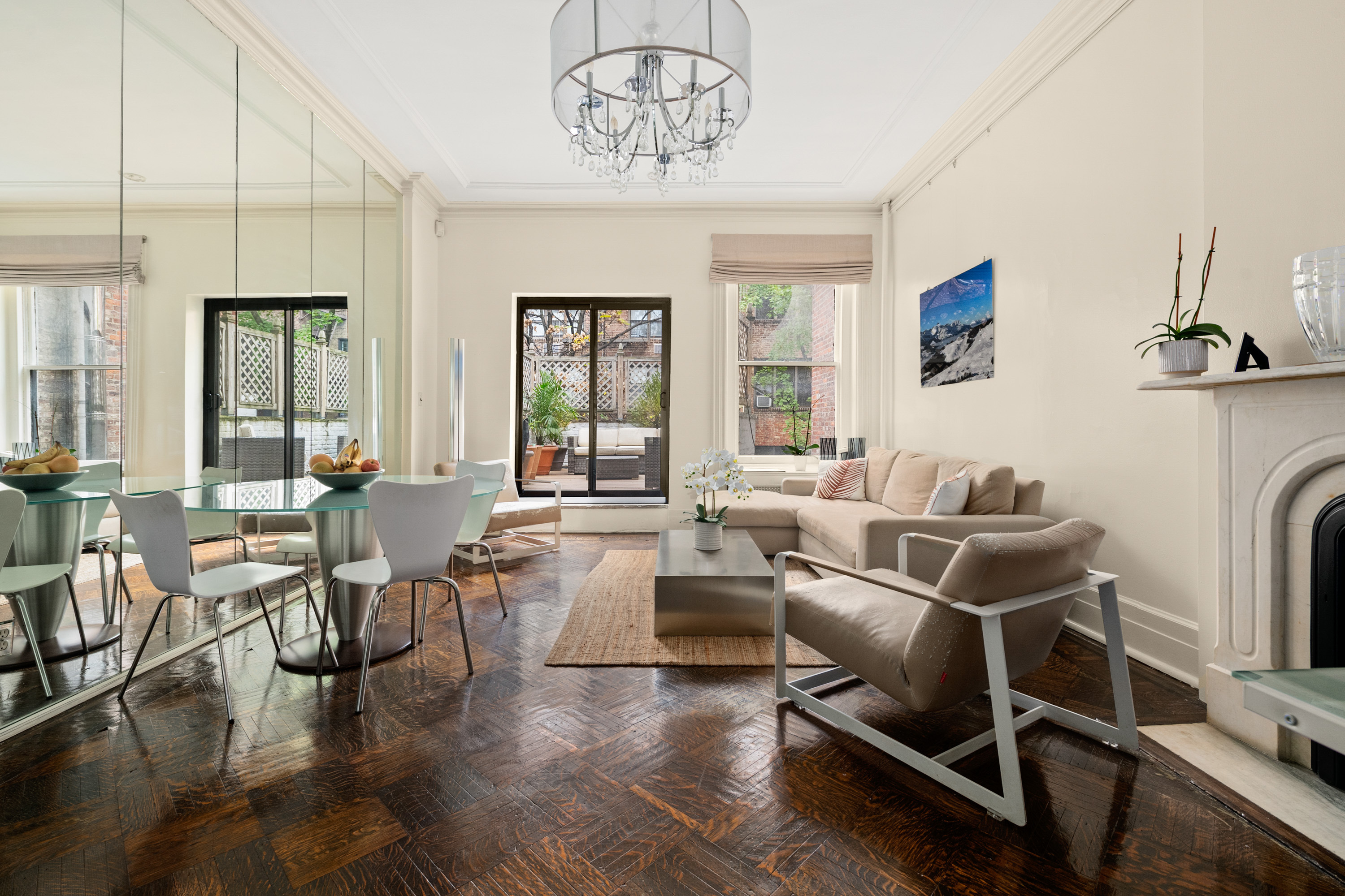 51 East 75th Street Manhattan, NY 10021 - Photo 13 of 22 a living room with furniture a dining table and a large window