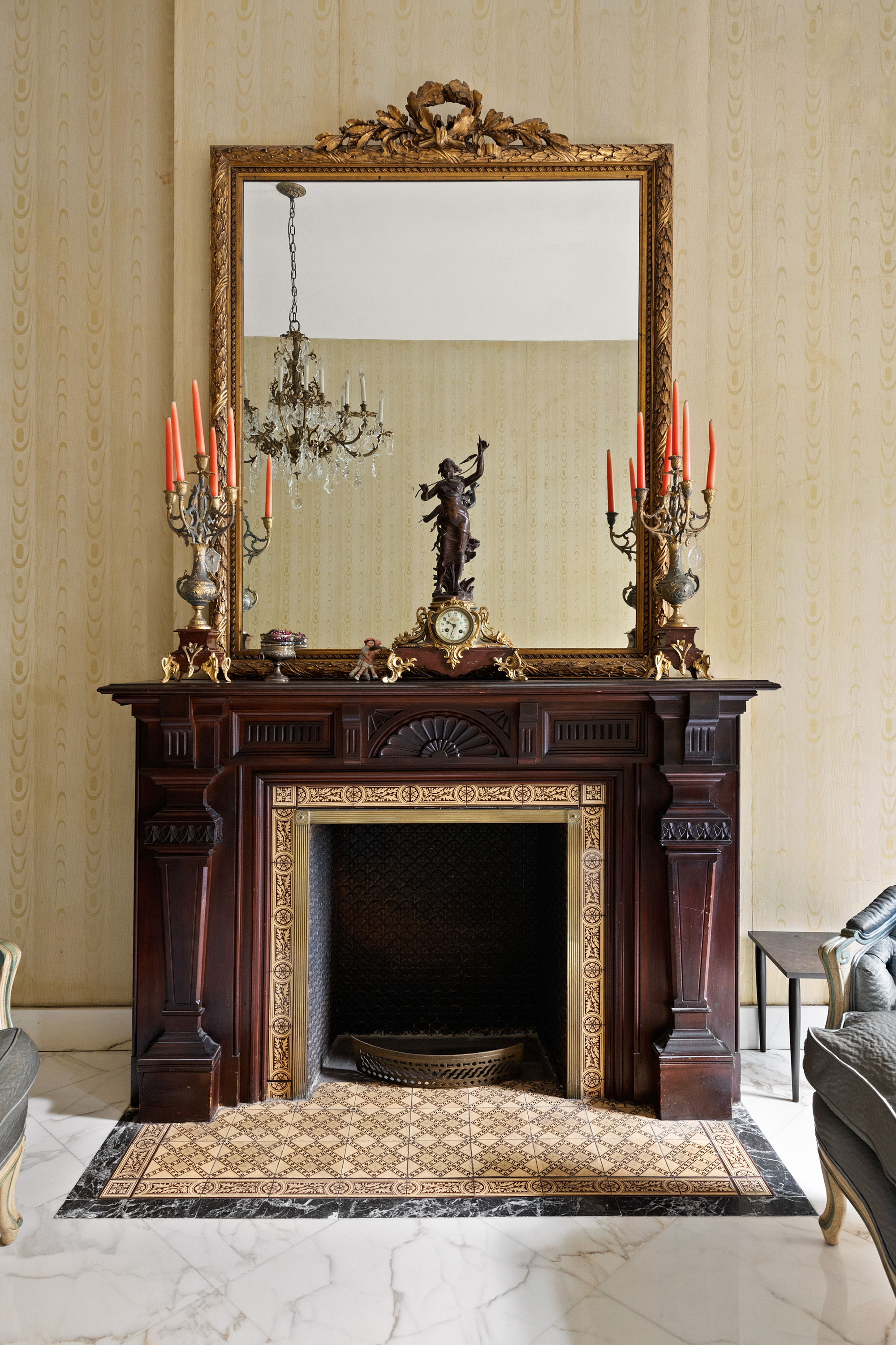 51 East 75th Street Manhattan, NY 10021 - Photo 5 of 22 a fireplace with a stove and a mirror