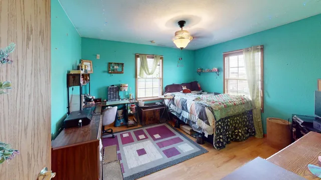 a bedroom with a bed and window