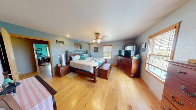 a living room with furniture a flat screen tv and gym equipment