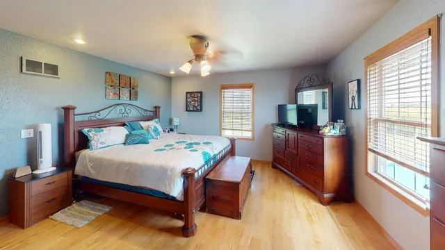 a living room with furniture a flat screen tv and a large window