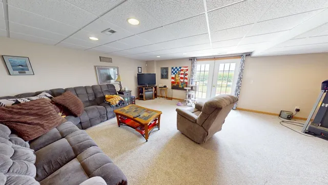 a backyard of a house with lots of green space and lake view