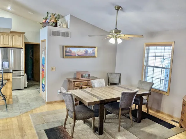 a living room with furniture and a kitchen view