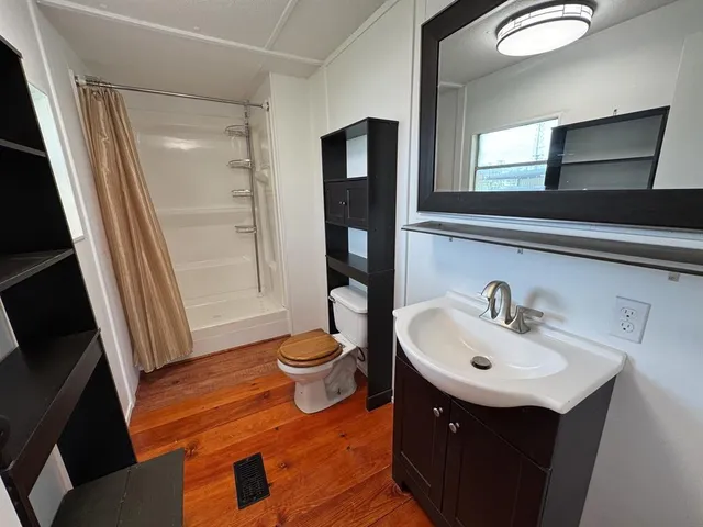 a bathroom with a toilet sink and a mirror