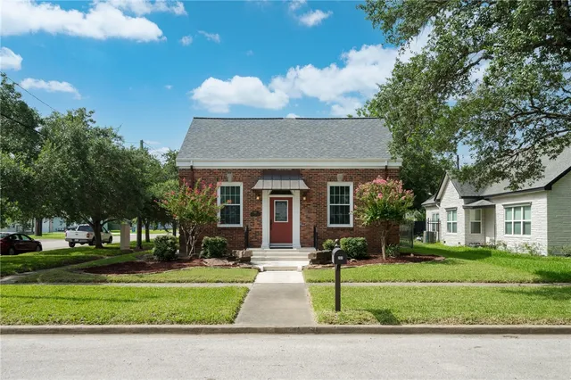 a front view of house with yard and green space