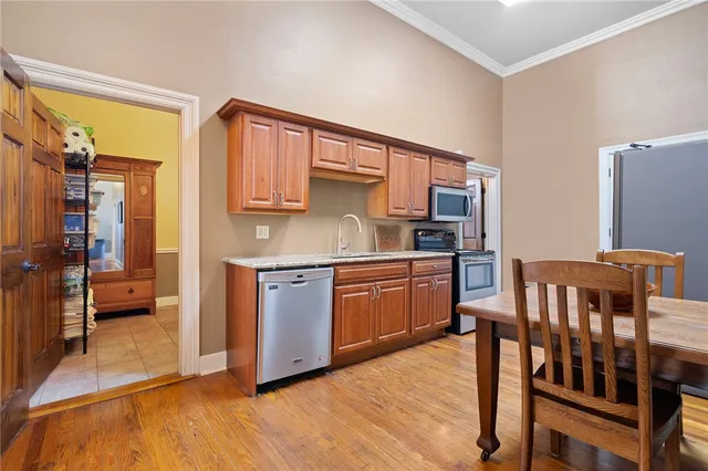a kitchen with stainless steel appliances granite countertop a refrigerator a stove a sink and dishwasher