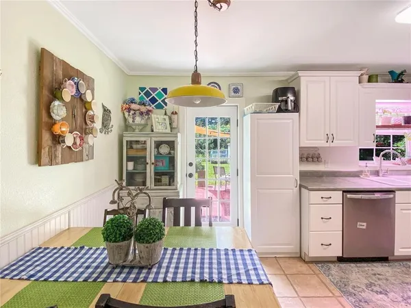 a room with furniture a rug and white walls