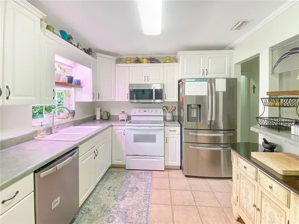 a kitchen with a sink cabinets and stainless steel appliances