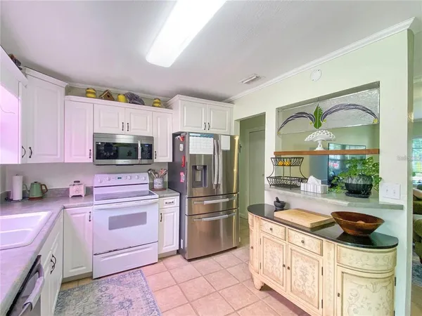 a kitchen with stainless steel appliances a stove a sink and a refrigerator