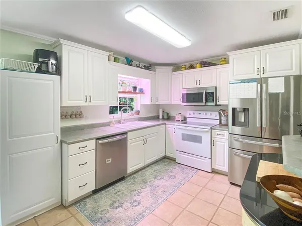 a kitchen with a sink cabinets and stainless steel appliances