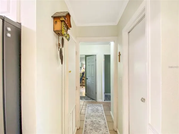 a view of a hallway with wooden floor and entryway