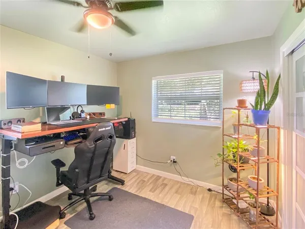 a view of workspace with wooden floor windows