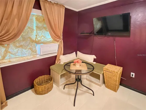 a balcony with table and chairs