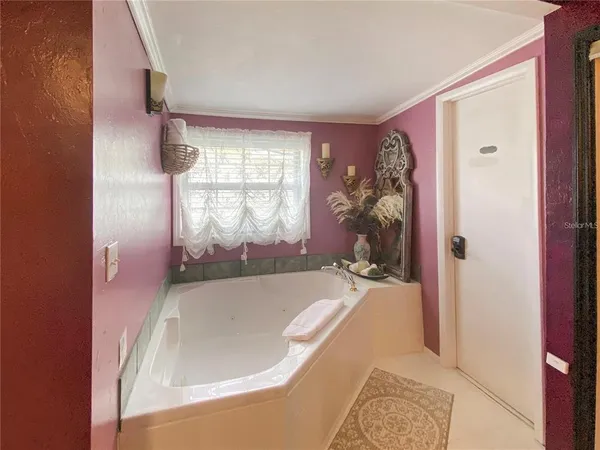 a en suite bathroom with a bathtub and window