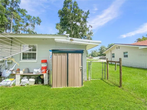 a view of a house with a backyard porch and sitting area