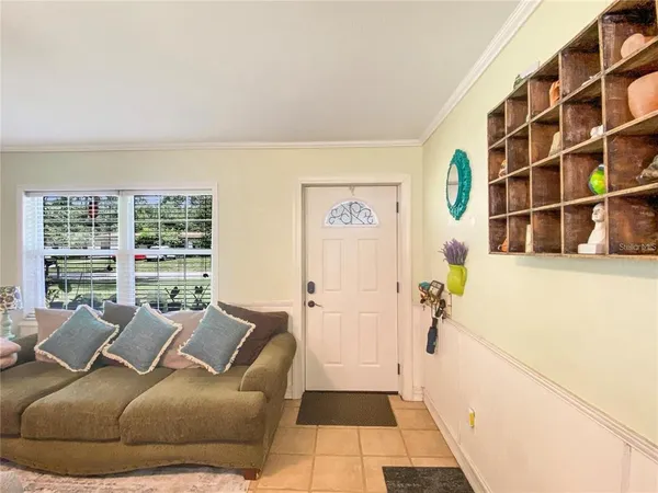a living room with furniture and a floor to ceiling window
