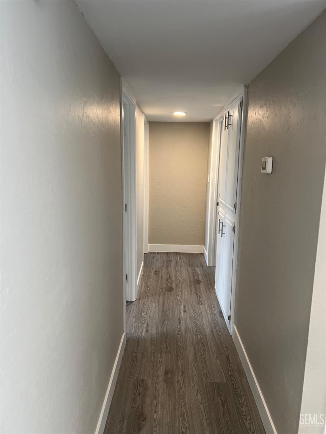 Undisclosed Address Bakersfield, CA 93308 - Photo 11 of 17 a view of hallway with wooden floor
