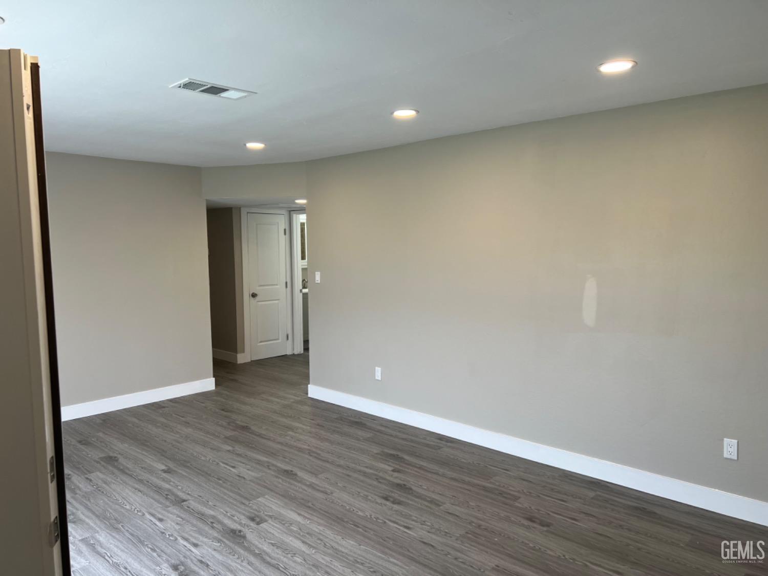 Undisclosed Address Bakersfield, CA 93308 - Photo 12 of 17 a view of an empty room with wooden floor